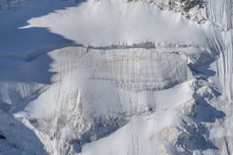 Intricate patterns of ice and rock are showcased in this stunning glacial landscape, revealing the