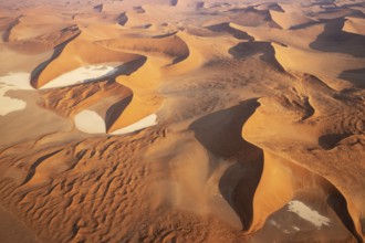 Sand dunes and dry pans in the Namib Desert. In the evening. Aerial view. Namib-Naukluft Park,
