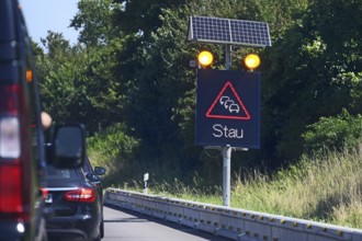 Traffic sign with solar-powered traffic jam warning on the motorway, Baden-Württemberg, Germany