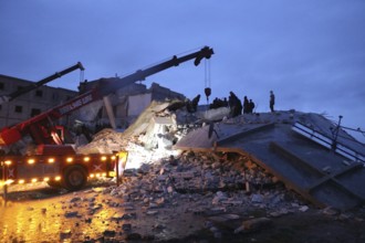 Civil defense teams attempt to rescue civilians trapped under the rubble after a powerful