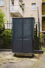 Heat pump in a backyard in Wuppertal, Germany, digitally reworked