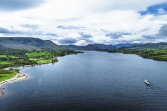 Farms and mountains over Ullswater Lake from drone, Pooley Bridge, Lake District National Park,
