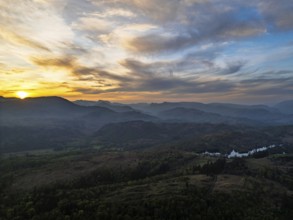 Sunset over Mountains and Coniston Water from drone, Lake District National Park, Cumbria, England,