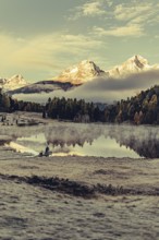 Lake Staz near Sankt Moritz in the Engadin in Switzerland. Morning atmosphere with fog in autumn.