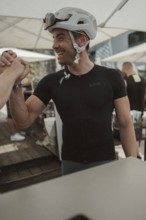 Young man riding a racing bike on Lake Garda. Sunny weather and dolce vita