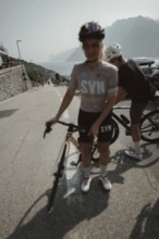 Woman and man riding racing bikes in Italy on Lake Garda