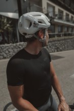Young man riding a racing bike on Lake Garda. Sunny weather and dolce vita