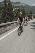 Woman and man cycling on Lake Garda in Italy. Sunny weather and dolce vita