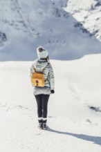 Woman in wintry surroundings in the Engadine in Switzerland