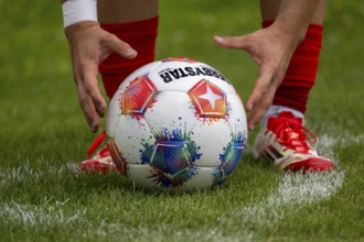 Footballer takes a corner kick***The ball is the official match ball of the Bundesliga and