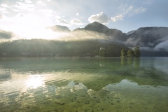 Mystical morning at Königssee in Schönau with boathouses and Christlieger. Sunrise and beautiful