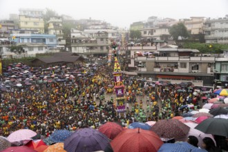 People from the Pnar community march in a circle around a Rot as they celebrate an event organised
