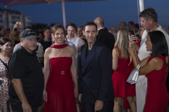 Hilary Swank and Marcel Remus walk through the crowd at the Remus Lifestyle Night on the rooftop
