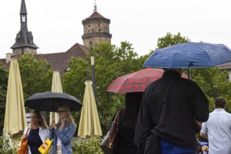 Rainy weather in Stuttgart. People with umbrellas hurry through the rain on Königstraße. Stuttgart,