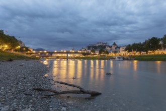 The city of Salzburg with the Salzach shines in the first light of summer morning