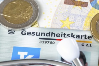 Health insurance contributions Symbolic image: health card, stethoscope and cash