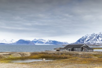 Wooden house against a mountain backdrop, Ny-Alesund, Spitsbergen, Svalbard