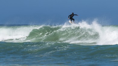 Surfer riding a wave on Contis beach, Saint Julien en Born, Saint-Julien-en-Born, Landes, France