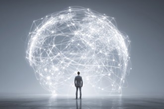 Businessman standing in front of the illuminated globe that shows light interconnections over the