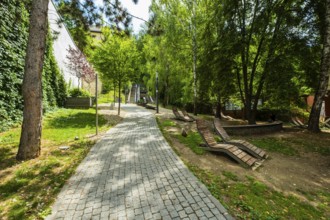 Small park with seating, a playground and a fountain at the entrance to Trencin Castle, Capital of