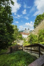 Small park with seating, a playground and a fountain at the entrance to Trencin Castle, Capital of