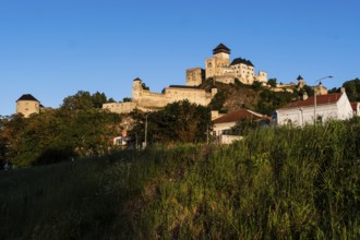 View of the castle and town of Trencín from the riverbank in the evening light, Capital of Culture