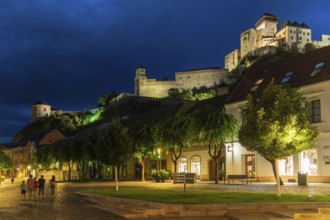 Night shot of the Peace Square in the historic centre of Trencín, Trencín Castle in the background,