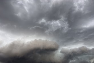 Below dark discoloured storm clouds Cloud roll above grey clouds Rain clouds heralding