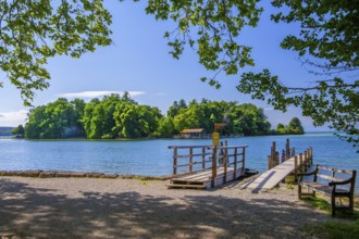 Bell jetty on the lakeshore with a view of Roseninsel in Lake Starnberg, Feldafing, Upper Bavaria,