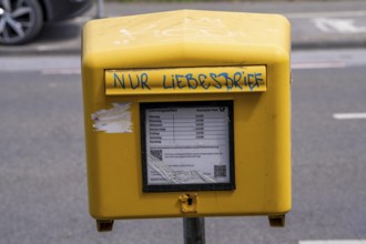 Deutsche Post letterbox, with stickers and graffiti, labelled Only love letters, Leverkusen, North