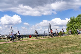 Cycle path in the Neulandpark in Leverkusen on the Rhine, in the background the new Rhine bridge of