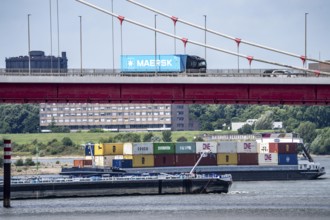 Barges on the Rhine at Ruhrort harbour, container freighter on uphill journey,