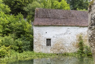 Old barn. The building is located near the source of the Zwiefalter Ach river at the Wimsen Cave