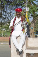 Indian man playing a long-necked spit lute or Ravanahattha, Udaipur, Rajasthan, India