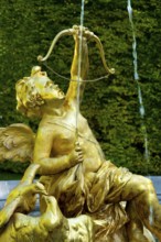Fountain figure of Cupid, god of love, in gold with bow and arrow, Rococo style, east parterre,