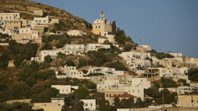 White houses and a church on an overgrown hill under a clear sky, Agia Marina, Leros, Dodecanese,