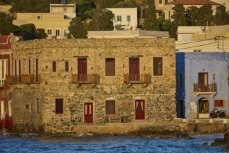 Old stone house by the sea under a blue sky with traditional Greek architecture, Agia Marina,
