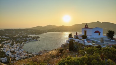 Profitis Ilias Church, Small church on a hill overlooking the calm sea at sunset, surrounded by a