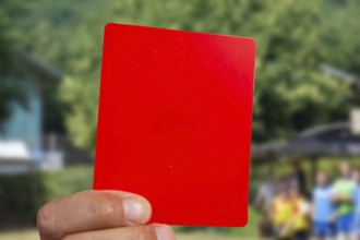 (Photomontage) Red card at a football match