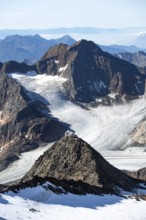 At the Wilder Freiger summit, picturesque high mountain landscape with snow, view of the
