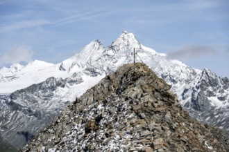 Summit cross of the summit Böses Weibl, behind summit of the Großglockner with snow, Schober group,