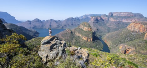 Hiker enjoying panorama, Blyde River Canyon with summit Three Rondawels, view of canyon with river