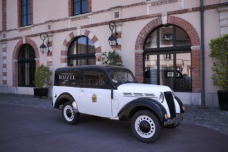 Black and white Renault Juvaquatre Editorial vintage car in front of headquarters, head office,