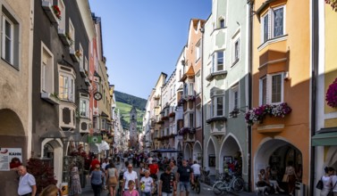 Old town, colourful houses in the main street, Zwölferturm tower at the back, old town, Sterzing,