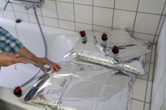 Filling a 10 litre water bag, for storing drinking water at home, as an emergency reserve in the
