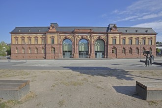 Old Post Office built in 1893 and sculpture of a woman wearing shoes, monument to the former shoe