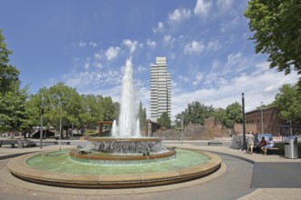 Round torch fountain by Friedrich Korter 1939 and town hall, water fountain with water basin, water
