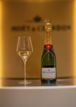 Bottle of Champagne Impérial Brut, filled glass, logo, lettering, headquarters of the champagne