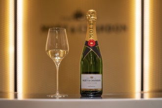 Bottle of Champagne Impérial Brut, filled glass, logo, lettering, headquarters of the champagne