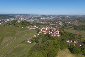 View of a city with surrounding nature and vineyards under a blue sky, view of Rotenberg near